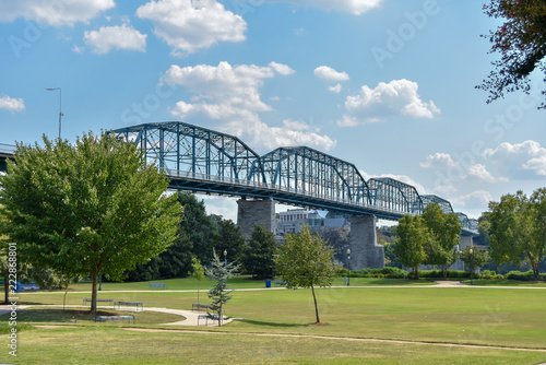 Blue bridge in Chattanooga, Tennessee running through a park on a sunny day © Chadd