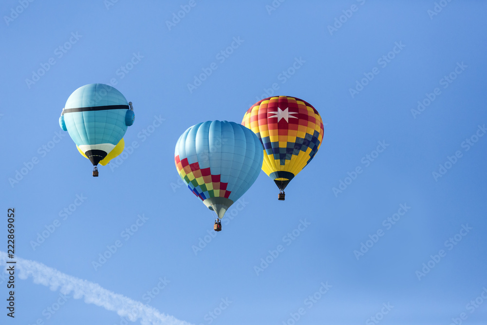 Naklejka premium Hot air balloons flying in a beautiful blue clear sky
