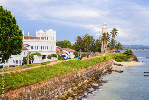 GALLE FORT, SRI LANKA - Sept. 21: View on the walls of Galle Fort in Sri Lanka. People walking on castle walls near the lightower and the mosque of sea fortress on Sept. 21 in Galle Fort, Sri Lanka.
