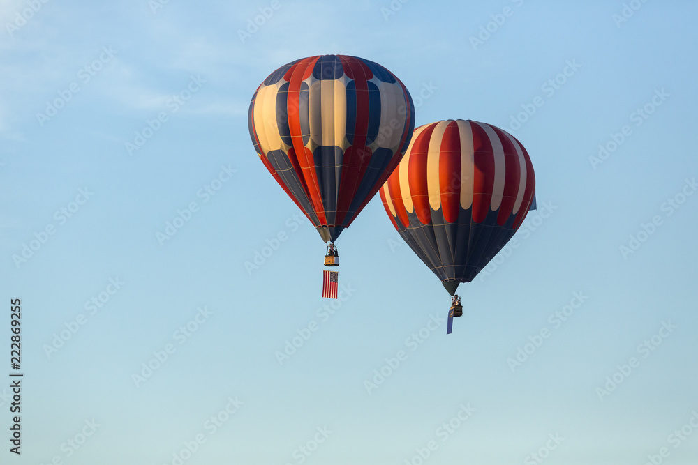 American flag and Nevada state flag flying with hot air balloons American flag and Nevada state flag flying with hot air balloons