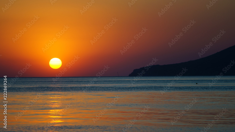Evening. Romantic sea sunset. The sun sinks into the sea.
