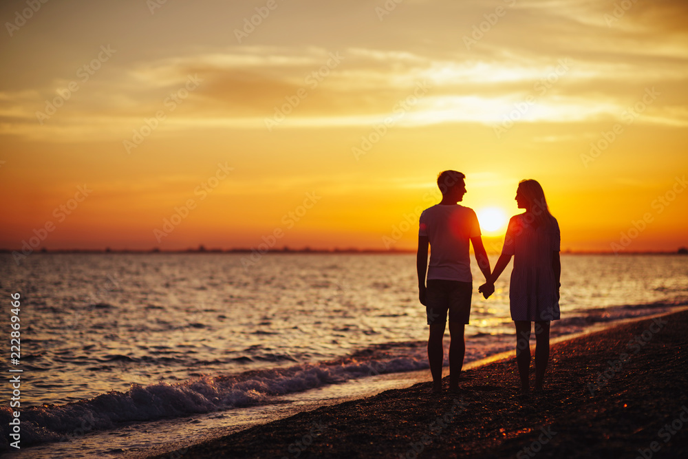 Young happy couple on seashore.