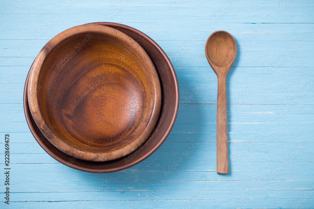 wooden dishware on blue wooden background