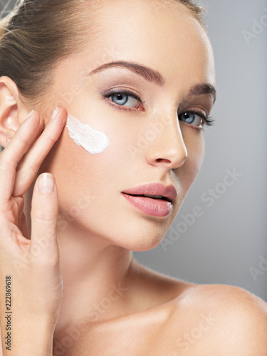 woman gets cream in the face. Skin care concept.