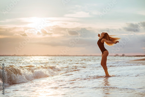 Outdoor lifestyle portrait of beautiful girl in black swimsuit © Margo Basarab