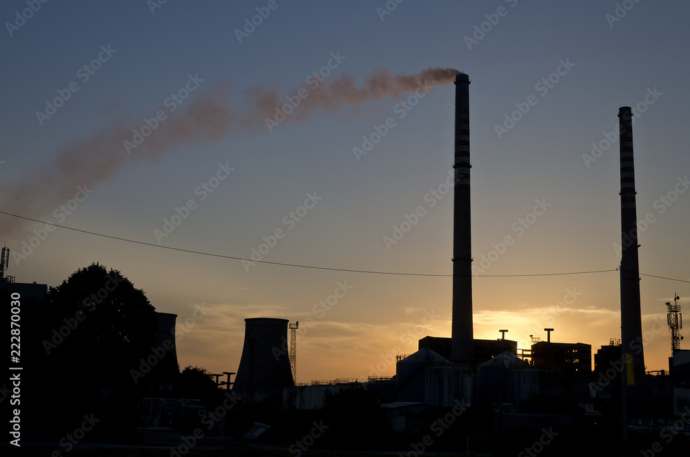 Coal Power Plant Smoking against the sunset