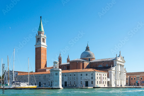 View of Church of San Giorgio Maggiore and Fondazione Giorgio Cini are located on one island of Venice, Italy. Palladio Venice architectures and parking yacht on island at Venice.