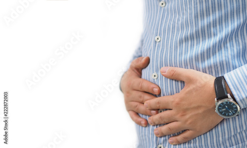 male person suffering from abdominal pain, person holding belly area with hands