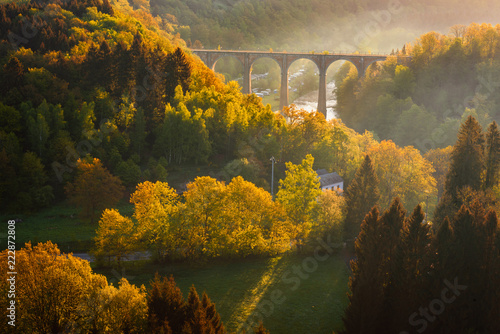 Ardennes, Belgium. Sunrise in countryside and forest near Herbeumont with wonderful viaduc of Hebeumont Viaduc of Conques across Semois river. Luxembourg province, Ardennes region, Wallonia, Belgium. photo