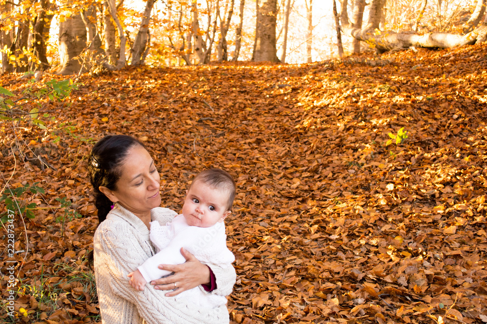Happy mother with his baby during fall season Happy mother with his baby during fall season
