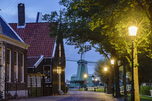 Night view of the beautiful dutch houses with De Gekroonde Poelenburg windmill at Zaandijk photo
