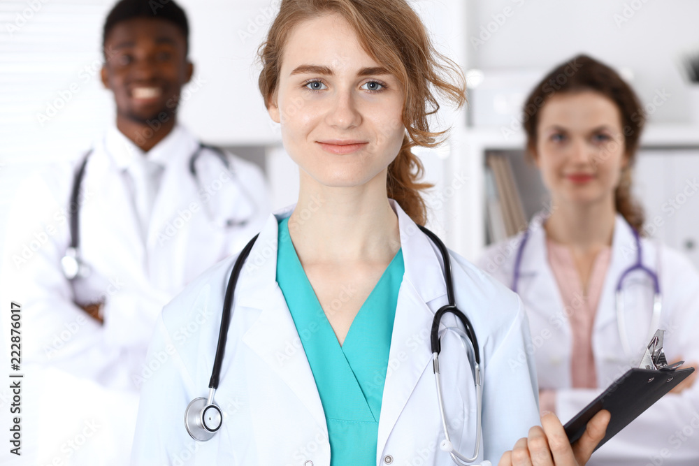 Happy doctor woman with medical staff at the hospital Happy doctor woman with medical staff at the hospital
