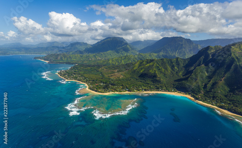 View of the beaches and mountains of Kauai's north coast with Tunnels Beach and the reef from Haena Point, aerial shot from a helicopter, Kauai, Hawaii.