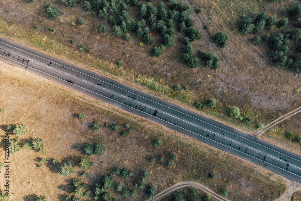 Aerial top view of asphalt road in rural area or countryside