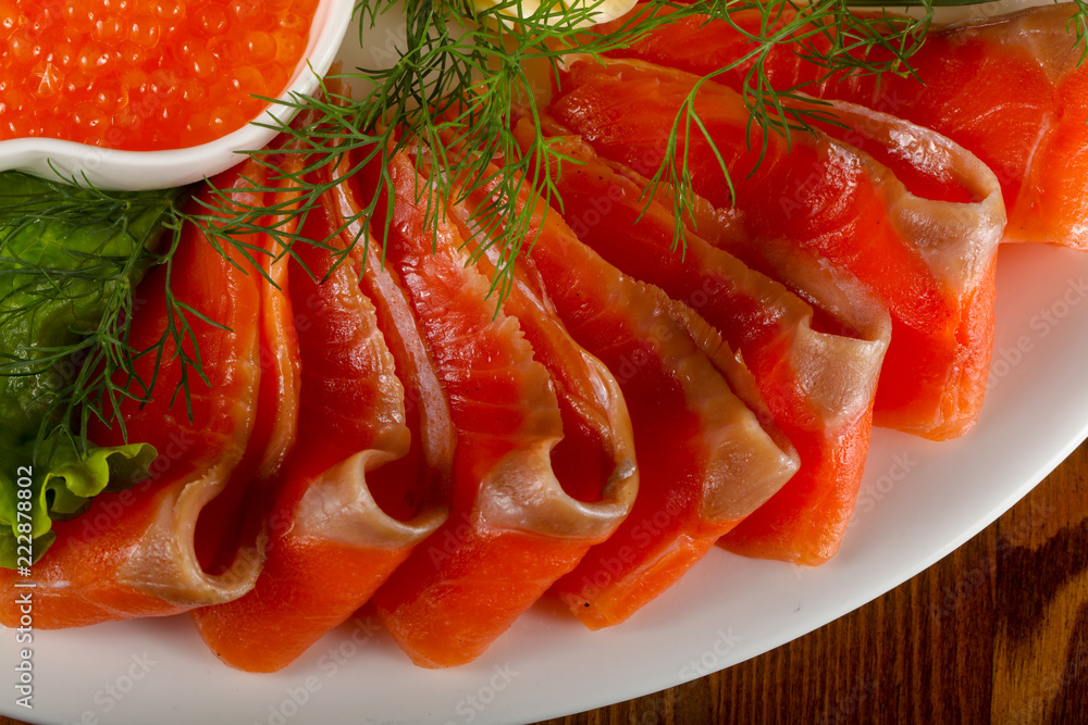 Sliced trout and red caviar