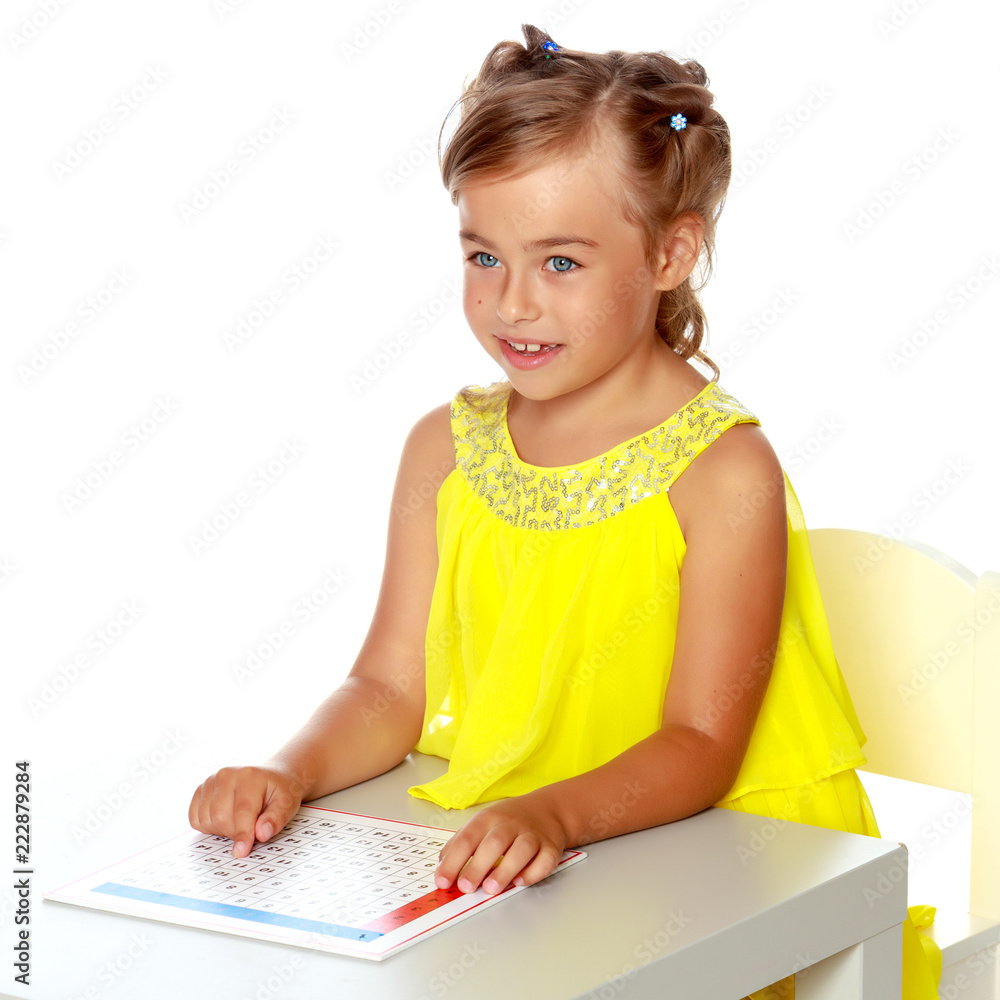 A little girl is studying Montessori stuff. A little girl is studying Montessori stuff.