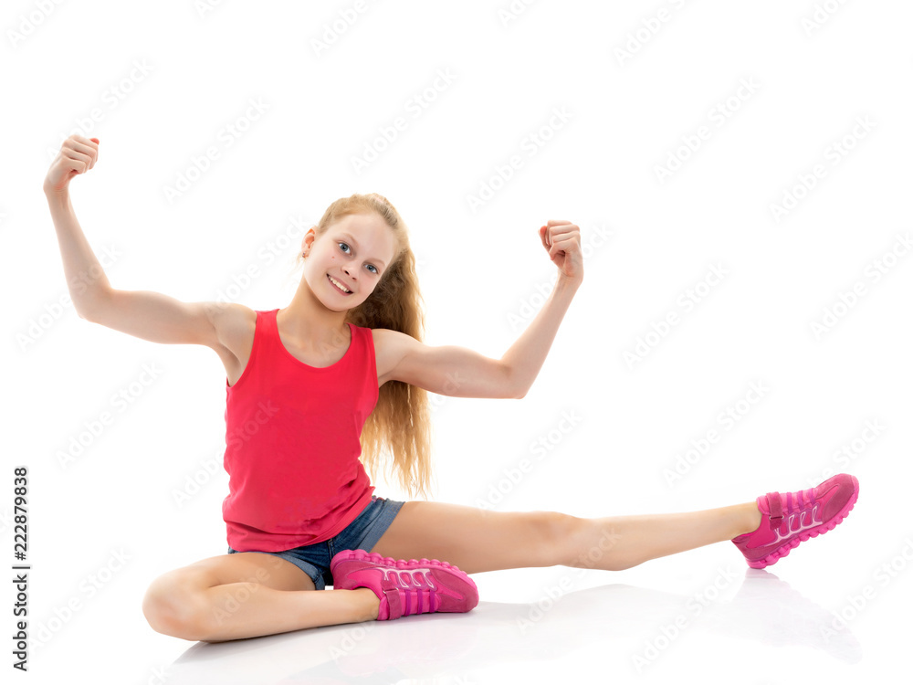 A little girl shows her muscles. A little girl shows her muscles.