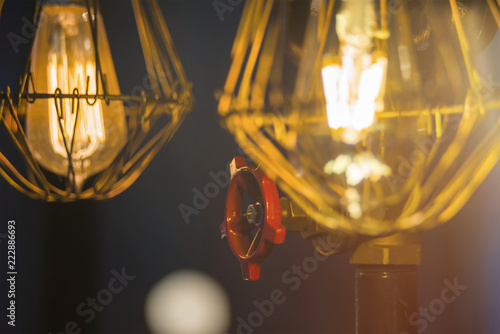 Old vintage red valve with old rusty metal pipes Lamp closeup with lens flare © ALEXANDR YURTCHENKO