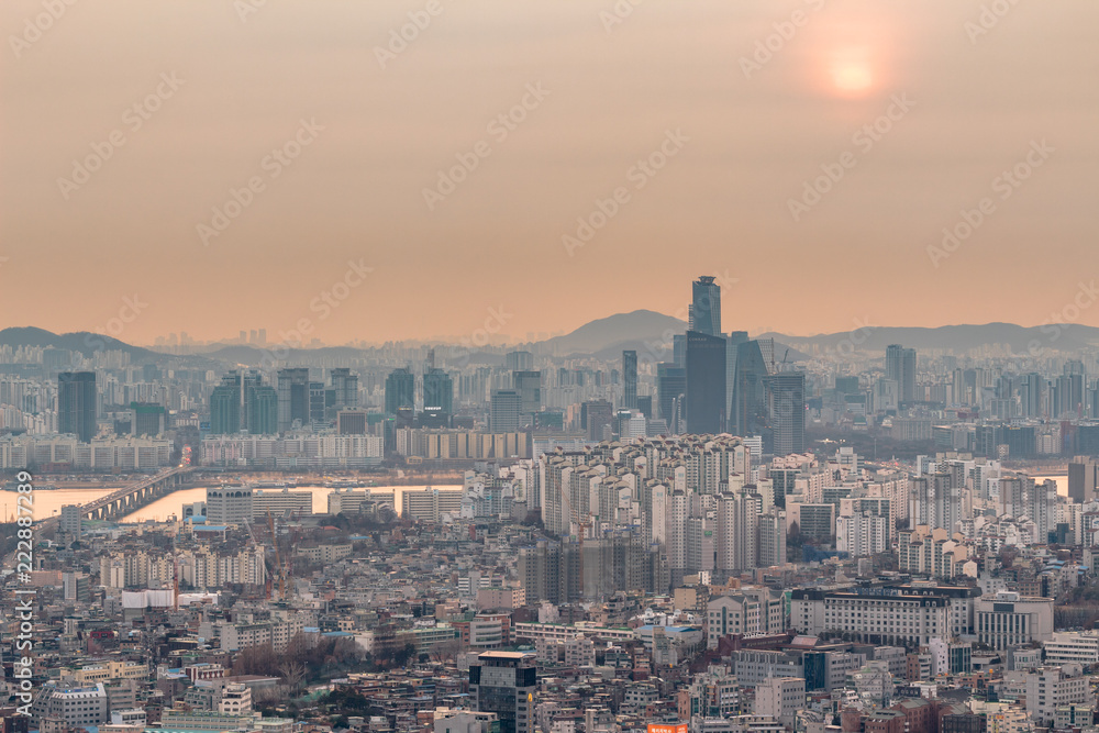 SEOUL, SOUTH KOREA - JAN 22, 2018: Aerial shot of Seoul skyline from Namsan Park and sun behind air pollution