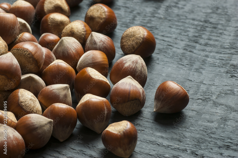 Hazelnuts on wooden backdrop. heap or stack of hazelnuts. Hazelnut background, healty food Hazelnuts on wooden backdrop. heap or stack of hazelnuts. Hazelnut background, healty food