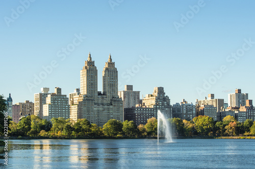 New York City Manhattan Central Park panorama, lake with fountain and skyscrapers on Background.