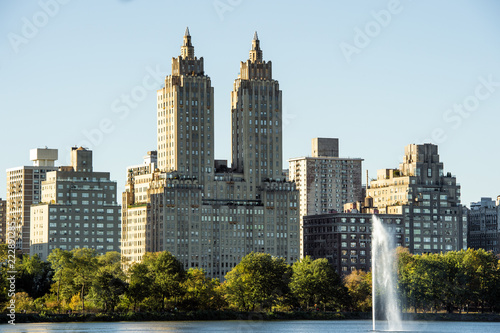 Fototapeta Naklejka Na Ścianę i Meble -  New York City Manhattan Central Park panorama, lake with fountain and skyscrapers on Background.