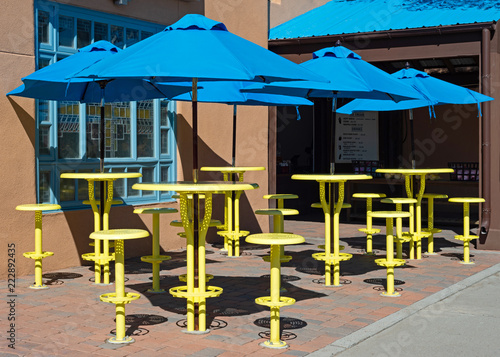 Yellow Tables with Blue Umbrellas photo