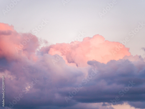 Gorgeous close up view of fluffy cumulus clouds with pink and purple hues resembling delicious mouthwatering cotton candy.