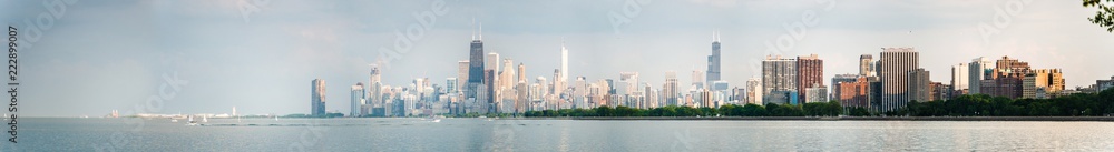 Gorgeous panoramic view of the Chicago skyline including new and old skyscrapers across the water of Lake Michigan.