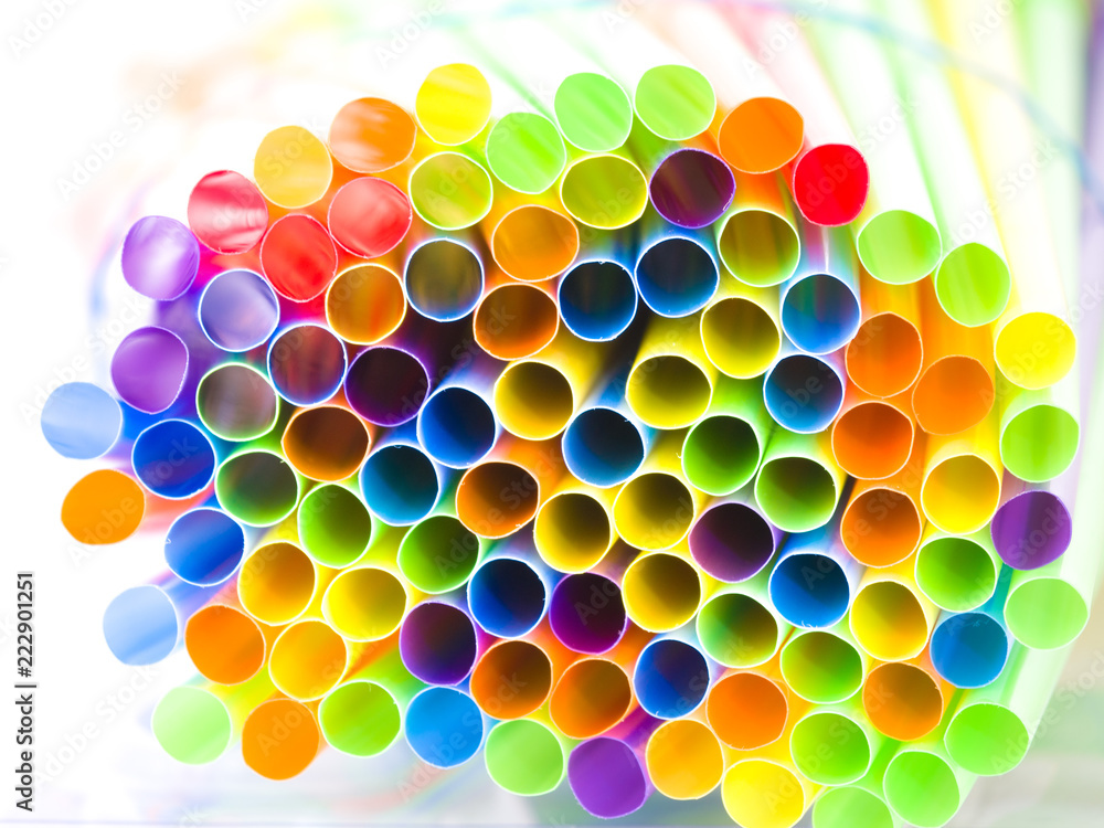 Closeup photograph of the ends of numerous multi colored neon bendy flexible straws including red, green, yellow, orange, blue, and purple making a vivid, vibrant, saturated and fun background image. Closeup photograph of the ends of numerous multi colored neon bendy flexible straws including red, green, yellow, orange, blue, and purple making a vivid, vibrant, saturated and fun background image.