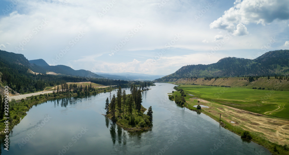 Aerial view of Trans-Canada Highway near Thompson River during a vibrant sunny summer day. Taken near Kamloops, BC, Canada. Aerial view of Trans-Canada Highway near Thompson River during a vibrant sunny summer day. Taken near Kamloops, BC, Canada.