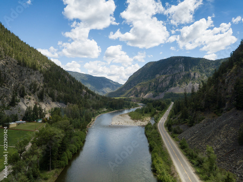 Aerial panoramic view of a scenic road going through the valley surrounded by the Beautiful Canadian Mountains. Located between Hope and Princeton, BC, Canada.