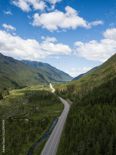 Aerial view of a scenic road going through the valley surrounded by the Beautiful Canadian Mountains. Located between Hope and Princeton, BC, Canada.