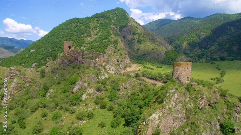 ruined fortress and tower on cliff on sunny day aerial view ruined fortress and tower on cliff on sunny day aerial view