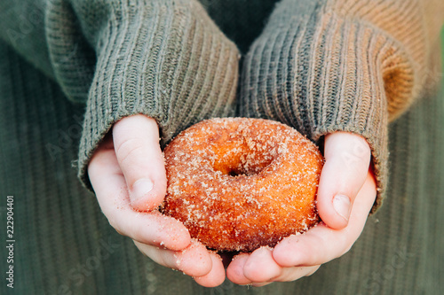 Apple cider donut with sugar with a comfy sweater