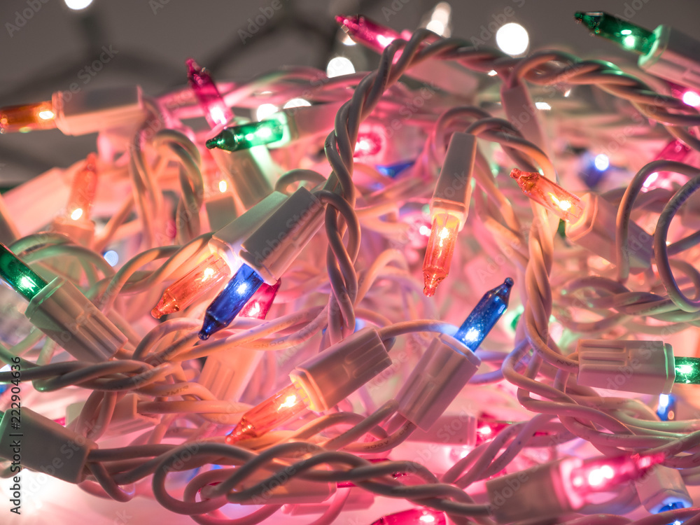Close up photograph of a pile of colored Christmas lights including green, blue, red, and orange making a festive holiday background. Close up photograph of a pile of colored Christmas lights including green, blue, red, and orange making a festive holiday background.