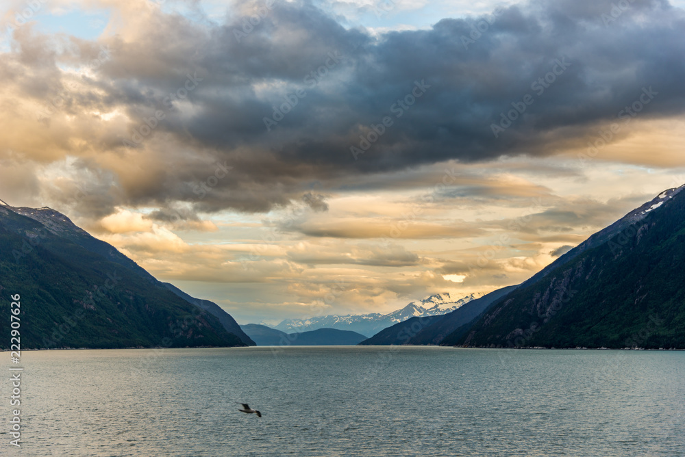 Mountains & Ocean with cloudy sky at sunset Glacier Bay Alaska