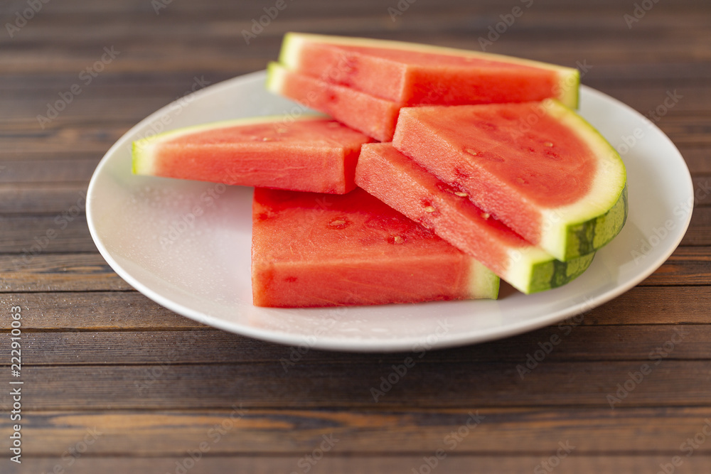 Red sliced watermelon on wooden table background Red sliced watermelon on wooden table background