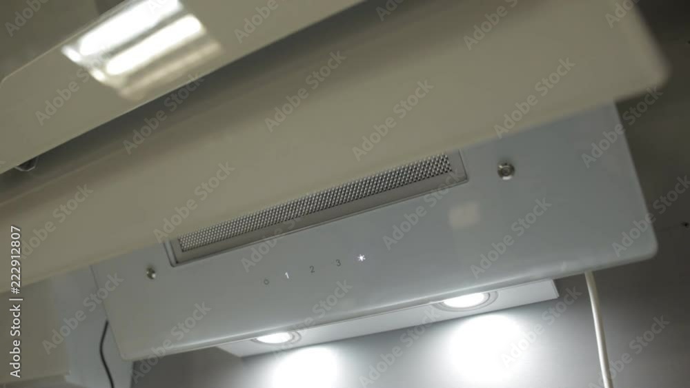The girl presses the buttons on a modern stylish white hood, close-up, design The girl presses the buttons on a modern stylish white hood, close-up, design