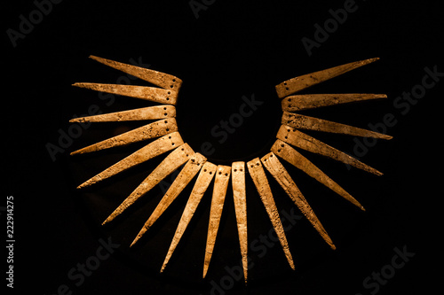 Ancient Inca necklace in black background.