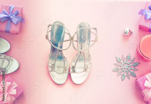 Christmas background pink Flat Lay fashion accessories sandals phone gift box bow balls purple.