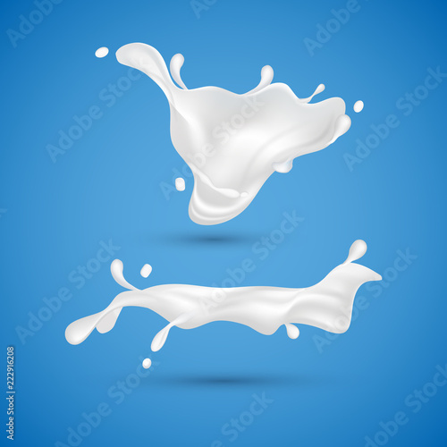Milk splashes isolated on blue background. Liquid yogurt cream. Milk dairy drink