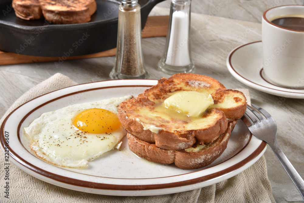 Golden buttery French toast with a fried egg Golden buttery French toast with a fried egg