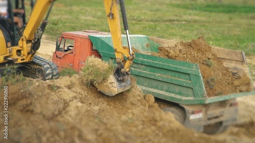 excavator loads a truck