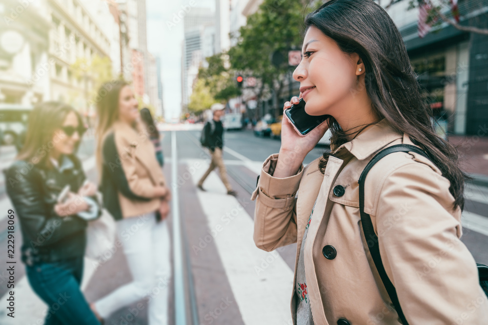 Fototapeta premium woman smiling and making phone call