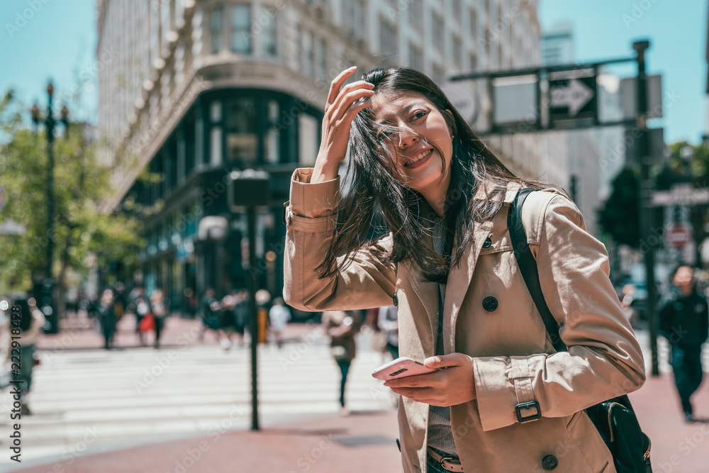 Fototapeta premium woman standing in street and looking happily