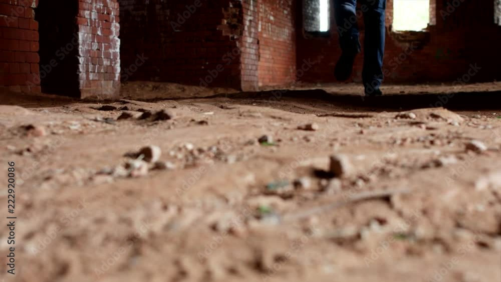 A young inspector examines an old building, a close-up, legs, an ancient structure, historian A young inspector examines an old building, a close-up, legs, an ancient structure, historian