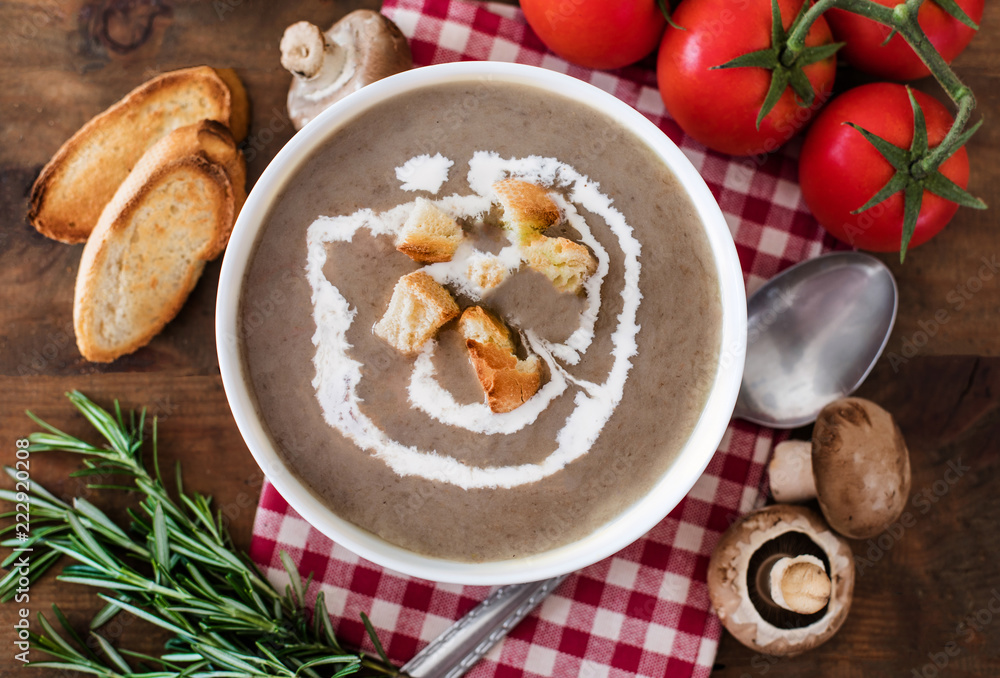 Mushroom cream soup with herbs and spices. Homemade, country styled chanterelle Cream-soup on wooden table. Mushroom cream soup with herbs and spices. Homemade, country styled chanterelle Cream-soup on wooden table.