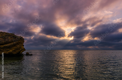 Sunset on the sea beach with stones