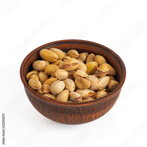 Bowl of pistachios on a white background